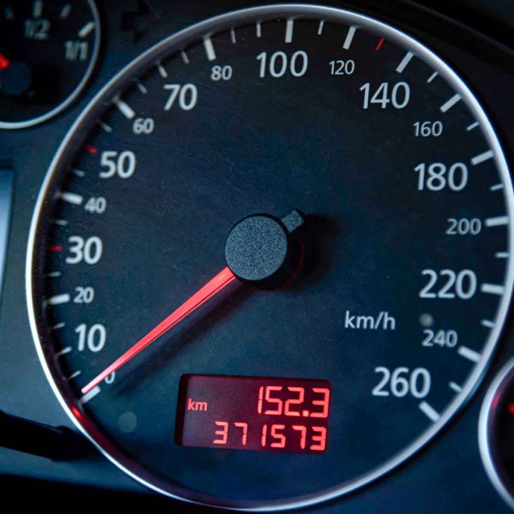 Close-up of a car odometer showing high mileage - should you buy a high-mileage car? Our guide