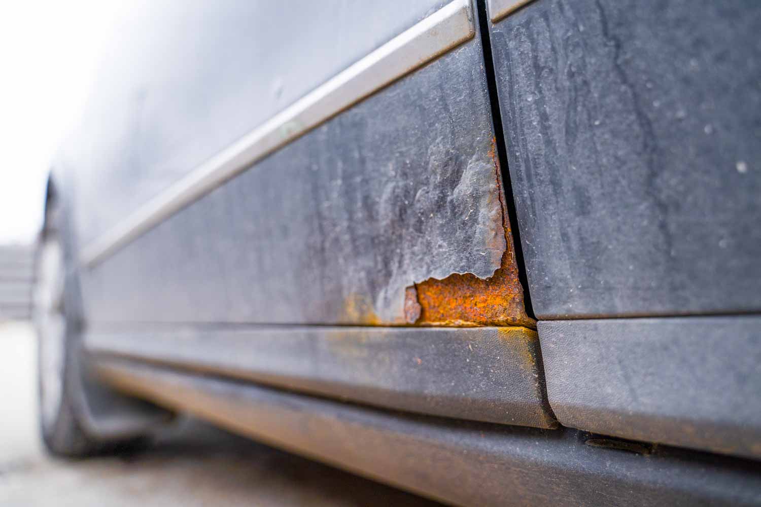 A rusted patch where the paint has bubbled and corrosion has worn some away - one of the things our guide to viewing a used car advises you to check